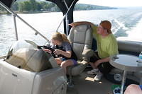 Julia driving the boat under Uncle Tom's supervision